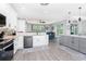 Bright kitchen featuring stainless steel appliances, quartz countertops, and an open layout to the living area at 1119 Boundary Blvd, Rotonda West, FL 33947