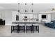 Spacious kitchen with a large island, white cabinets, gray accent, and modern lighting at 1119 Boundary Blvd, Rotonda West, FL 33947