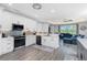 Open-concept kitchen with modern appliances, white cabinets, and seamless flow to the living area at 1119 Boundary Blvd, Rotonda West, FL 33947