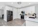 Contemporary kitchen featuring stainless steel appliances, white cabinets, and stylish backsplash at 1119 Boundary Blvd, Rotonda West, FL 33947