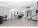 Open-concept living area featuring wood-look flooring, recessed lighting, and stylish furnishings at 1119 Boundary Blvd, Rotonda West, FL 33947