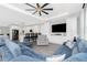 Living room featuring a comfortable blue sofa set, integrated entertainment center, and an open-concept design at 1119 Boundary Blvd, Rotonda West, FL 33947