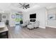 Cozy living area with comfortable seating, modern fireplace, and view of the outdoor pool at 1119 Boundary Blvd, Rotonda West, FL 33947