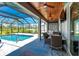 Covered patio with outdoor seating, a pool view, and lovely wood ceiling at 1119 Boundary Blvd, Rotonda West, FL 33947