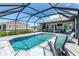 Relaxing screened-in pool area with lounge chairs, and exterior view of the house making it perfect for entertaining at 1119 Boundary Blvd, Rotonda West, FL 33947