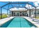 Beautiful screened-in pool featuring a built-in spa, perfect for relaxation and outdoor entertaining at 1119 Boundary Blvd, Rotonda West, FL 33947