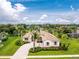 Aerial view of a single-Gathering home with mature landscaping and a long driveway at 117 Abercrombie Ave, Englewood, FL 34223