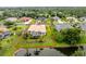 A nice aerial view of the home showing the beautiful landscaping, screened-in lanai, and serene pond at 117 Abercrombie Ave, Englewood, FL 34223