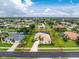 Aerial view of home with mature landscaping, a screened lanai, and neighboring homes at 117 Abercrombie Ave, Englewood, FL 34223