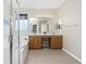 Bathroom featuring glass shower, soaking tub, dual sink vanity, and large mirror at 117 Abercrombie Ave, Englewood, FL 34223