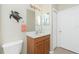 Well-lit bathroom features a wood vanity, white countertop, decorative turtle, and neutral walls at 117 Abercrombie Ave, Englewood, FL 34223