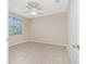 A bright bedroom with tile flooring and a window providing ample natural light at 117 Abercrombie Ave, Englewood, FL 34223