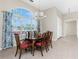 Dining room with traditional wood table and chairs and lots of light at 117 Abercrombie Ave, Englewood, FL 34223