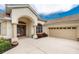 Charming single-Gathering home with a tile roof, arched entry, and attached garage at 117 Abercrombie Ave, Englewood, FL 34223