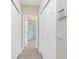Hallway featuring tile floors and access to bathroom with a glass shower at 117 Abercrombie Ave, Englewood, FL 34223