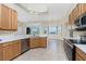 Kitchen with stainless steel appliances, and light wood cabinets provides easy access to the breakfast bar and dining area at 117 Abercrombie Ave, Englewood, FL 34223