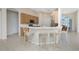 Bright kitchen with breakfast bar seating and natural wood cabinets at 117 Abercrombie Ave, Englewood, FL 34223