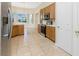 Kitchen with wooden cabinets, stainless steel appliances, tile flooring, and access to the breakfast area at 117 Abercrombie Ave, Englewood, FL 34223