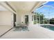 Covered lanai with a ceiling fan and view of pool and backyard at 117 Abercrombie Ave, Englewood, FL 34223