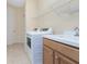 Bright laundry room features updated washer, dryer, and additional storage space at 117 Abercrombie Ave, Englewood, FL 34223