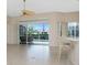 Bright living area featuring an outdoor view, tile flooring, and a modern ceiling fan at 117 Abercrombie Ave, Englewood, FL 34223