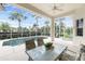 Enclosed patio area featuring a pool, table, and chairs perfect for entertaining or relaxation at 117 Abercrombie Ave, Englewood, FL 34223