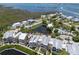 Breathtaking aerial view of waterfront homes with canal access, pond, and community pool at 11780 Anglers Club Dr # 107, Placida, FL 33946