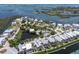 Incredible aerial view of waterfront homes with canal access, pond, community pool, and direct gulf access at 11780 Anglers Club Dr # 107, Placida, FL 33946