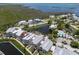 Serene aerial view of waterfront homes with canal access, pond, community pool, and direct gulf access at 11780 Anglers Club Dr # 107, Placida, FL 33946