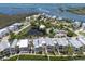 Picturesque aerial view of waterfront homes with canal access, pond, community pool, and gulf access at 11780 Anglers Club Dr # 107, Placida, FL 33946