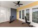 This covered balcony features a ceiling fan, wood-look floor and double french doors at 11780 Anglers Club Dr # 107, Placida, FL 33946