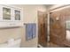 Bathroom featuring a glass door shower with tile surround, towel hooks, and a two-door cabinet at 11780 Anglers Club Dr # 107, Placida, FL 33946