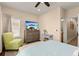 Comfortable bedroom featuring a mounted tv and stylish decor; access to a balcony at 11780 Anglers Club Dr # 107, Placida, FL 33946