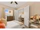 Serene bedroom with a vanity, dresser, and open view into the living area with a large television at 11780 Anglers Club Dr # 107, Placida, FL 33946