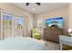 Light-filled bedroom with ceiling fan, comfortable seating, and sliding glass doors to a balcony at 11780 Anglers Club Dr # 107, Placida, FL 33946