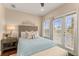 Bright bedroom with a queen bed, stylish decor, and access to an outdoor balcony at 11780 Anglers Club Dr # 107, Placida, FL 33946