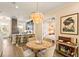 Dining area connected to the kitchen with stylish lighting and modern island seating at 11780 Anglers Club Dr # 107, Placida, FL 33946