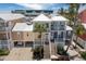 Charming two-story coastal home featuring a metal roof, double balconies, and lush tropical landscaping at 11780 Anglers Club Dr # 107, Placida, FL 33946