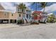 Attractive multi-story home with carport, palm trees, and well-maintained landscaping at 11780 Anglers Club Dr # 107, Placida, FL 33946