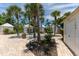 Charming cottage-style shed near beautiful tropical landscaping with brick pavers at 11780 Anglers Club Dr # 107, Placida, FL 33946