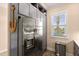 Kitchen featuring stainless steel refrigerator, grey cabinetry, a view of the lake and trash can at 11780 Anglers Club Dr # 107, Placida, FL 33946