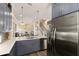 Open-concept kitchen showcasing stainless steel appliances, grey cabinetry, and easy access to living areas at 11780 Anglers Club Dr # 107, Placida, FL 33946