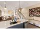 An open-concept living and dining area featuring stylish decor, modern lighting, and an elegant staircase at 11780 Anglers Club Dr # 107, Placida, FL 33946