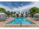 Large community pool area with brick pavers, multiple lounge chairs, and several cabanas at 11780 Anglers Club Dr # 107, Placida, FL 33946