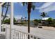 Scenic neighborhood view from porch overlooking a pond and other attractive homes and landscaping at 11780 Anglers Club Dr # 107, Placida, FL 33946