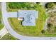 Overhead view of home with a grey roof and expansive lawn at 123 Ferdon Cir, Port Charlotte, FL 33954