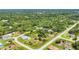 Aerial view of home site, surrounded by trees, green space and winding road at 123 Ferdon Cir, Port Charlotte, FL 33954