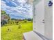 Spacious backyard featuring lush green grass and a large door at 123 Ferdon Cir, Port Charlotte, FL 33954