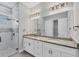Bathroom boasting double sinks, granite countertops, and a glass-enclosed shower with tile accents at 123 Ferdon Cir, Port Charlotte, FL 33954