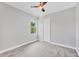 This bedroom features a ceiling fan, closet and view from the window at 123 Ferdon Cir, Port Charlotte, FL 33954